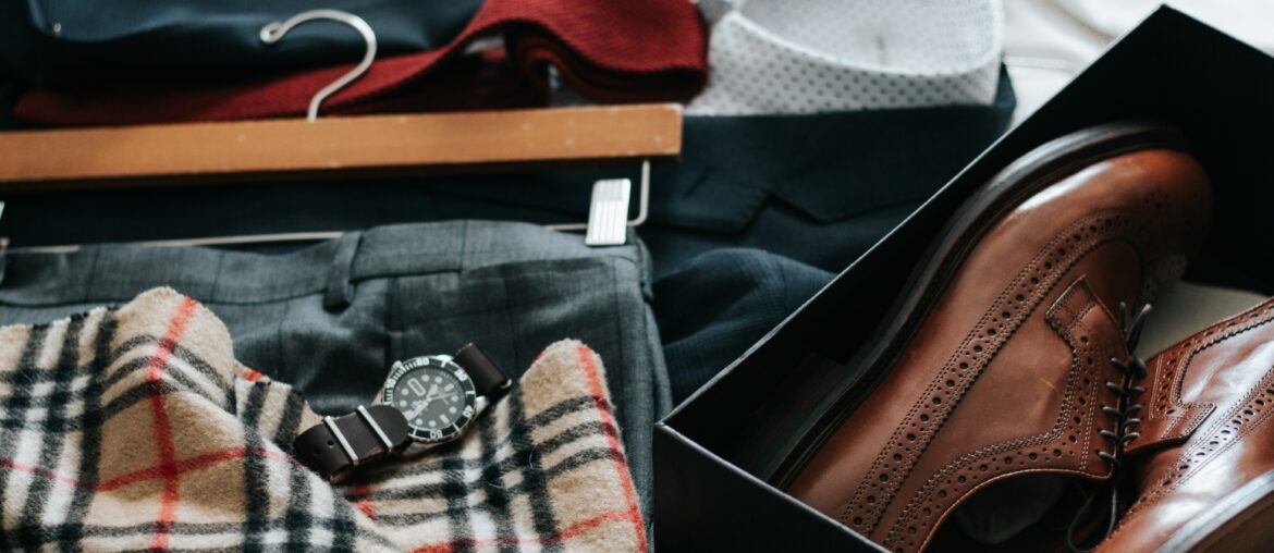 dress shoes, watch, checkered scarf and dress pants laid out