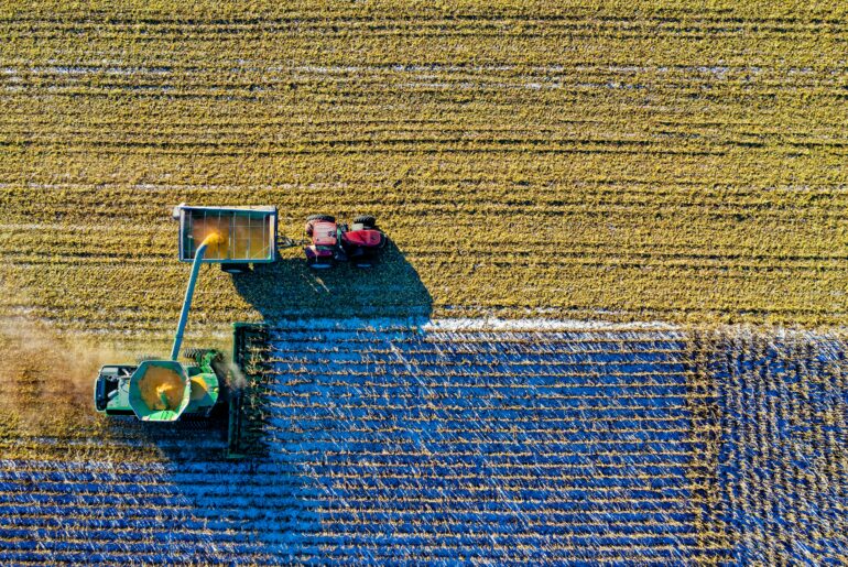 Top view of green field with tractors