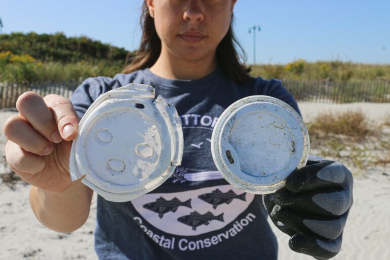 A pair of single use plastic coffee lids found during a beach cleanup in Massachusetts.