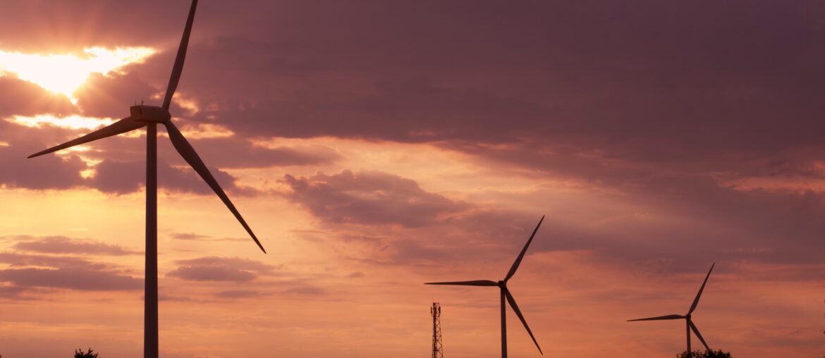 wind farm at sunset with clouds