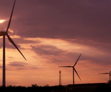 wind farm at sunset with clouds