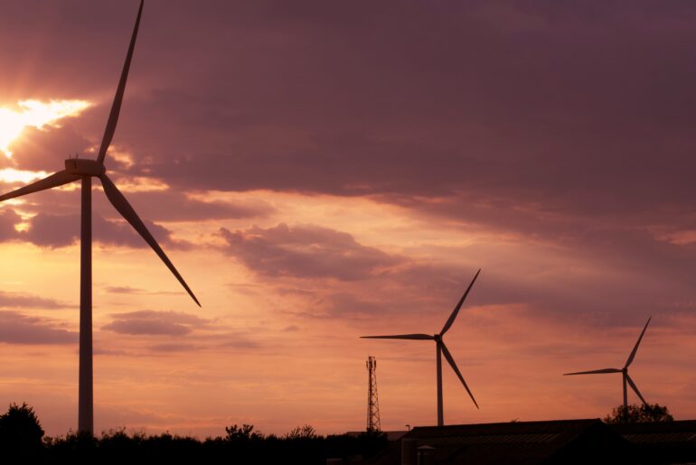 wind farm at sunset with clouds